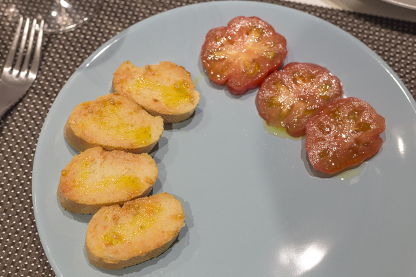Bread in slices with tomato on a grey dish - Photo, Image