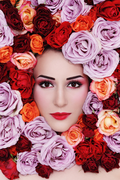 woman with colorful roses around face - Фото, изображение