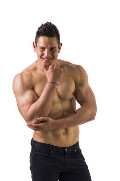 Muscular young bodybuilder in relaxed pose, smiling - Foto, afbeelding
