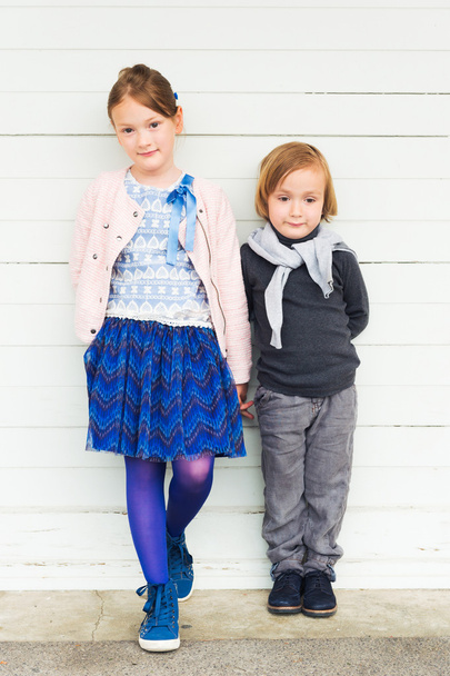 Two fashion kids against white wooden wall - Photo, image