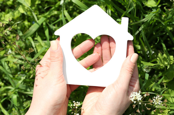 Female hands holding toy house outdoors - Photo, Image