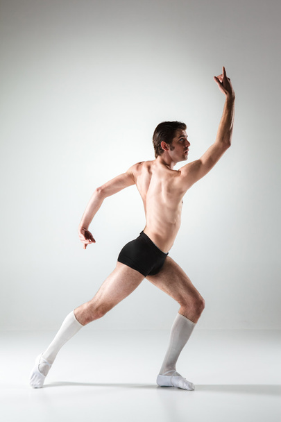 The young attractive modern ballet dancer on white background - 写真・画像