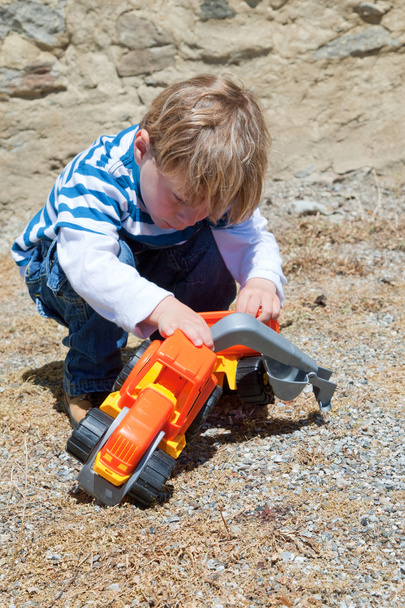 little boy playing with plastic toy - Fotó, kép