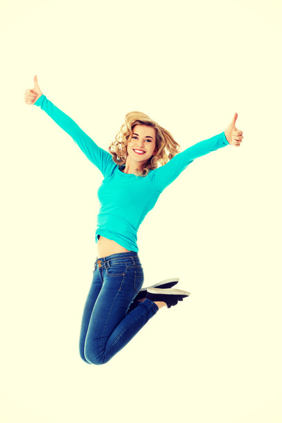 Young casual woman, student jumping. - Foto, Bild