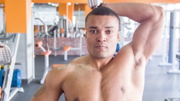 Cute heavy-weight sportsman is exercising with dumbbell - Filmagem, Vídeo