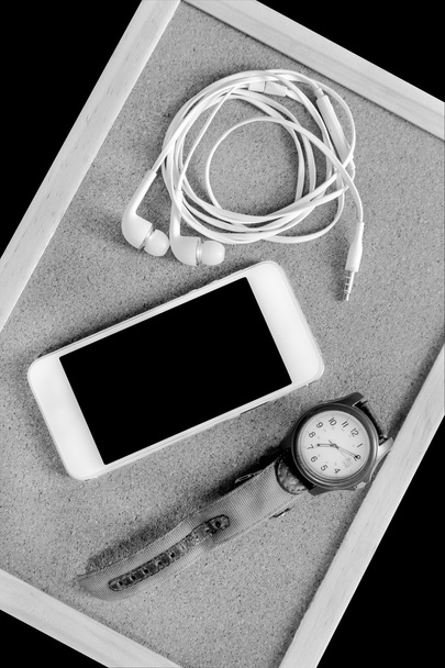 Mobile phone with earphone and wristwatch - 写真・画像