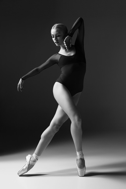 Young beautiful modern style dancer posing on a studio background - Фото, изображение