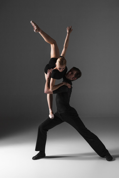 two young modern ballet dancers on gray studio background  - Fotó, kép
