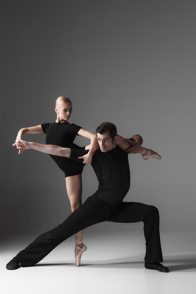 two young modern ballet dancers on gray studio background  - 写真・画像