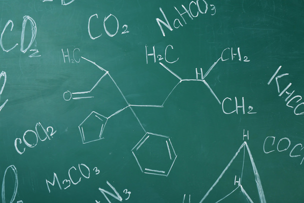 Molecule models and formulas on blackboard background - Фото, зображення