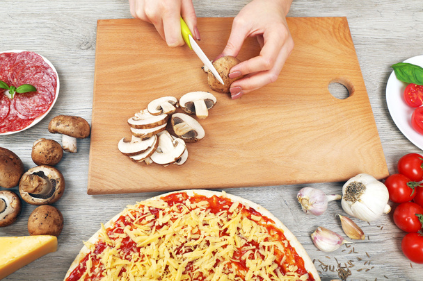 Woman making pizza on table close up - Foto, Bild