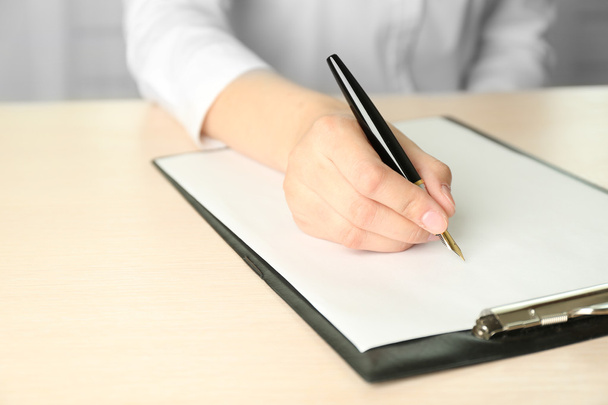 Businesswoman writing on document - Photo, image