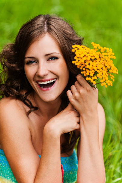 Portrait young gay beautiful woman holding bouquet yellow wildfl - Photo, Image