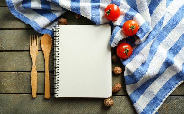 Open recipe book, vegetables and spices on wooden background - Fotó, kép