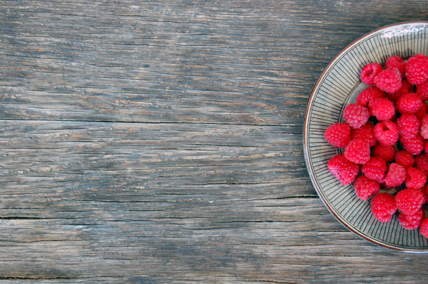 Raspberries on rustic wooden table - Photo, Image
