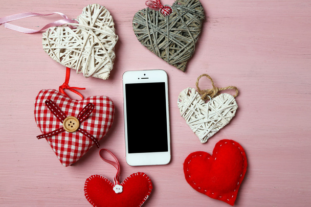 White smart phone with hearts - Фото, изображение