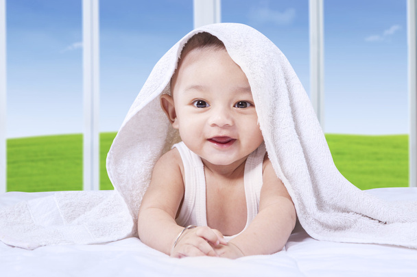Adorable baby with cute face on the bed - Φωτογραφία, εικόνα