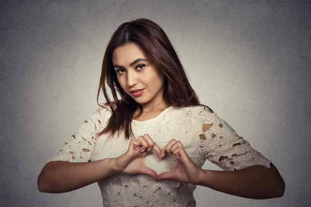 smiling happy young woman making heart sign with hands - Фото, изображение