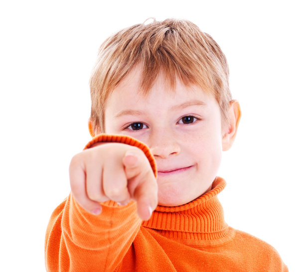 Boy pointing with finger against a white background - Foto, Imagen