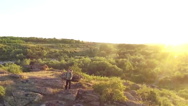 Man  hiker tourist on mountain against sunset. Aerial top view - Felvétel, videó