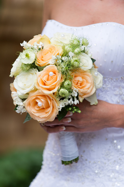 Beautiful wedding bouquet in hands of the bride - 写真・画像