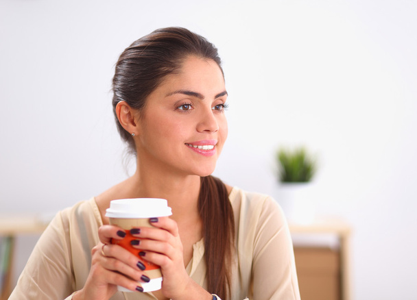 Beautiful  businesswoman enjoying coffee in bright office - Zdjęcie, obraz