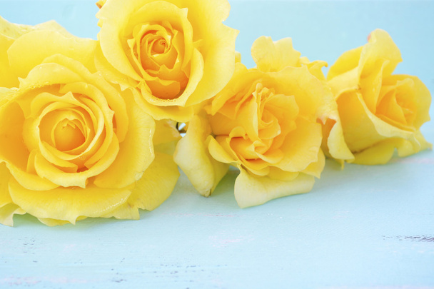 Beautiful yellow roses on rustic wood table.  - Photo, Image