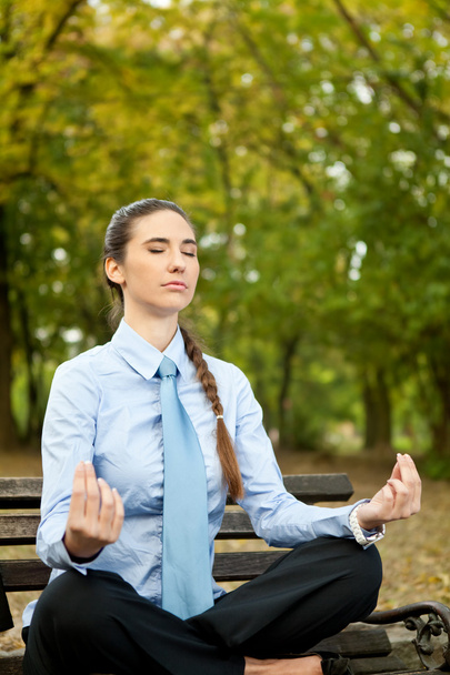 Woman in suit doing yoga - Photo, Image