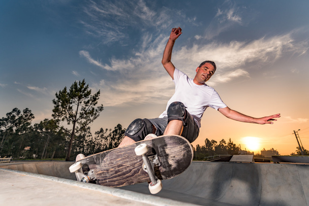 Skateboarder in a concrete pool  - Fotó, kép