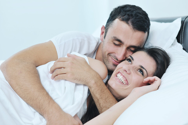 Young couple have good time in their bedroom - Фото, изображение