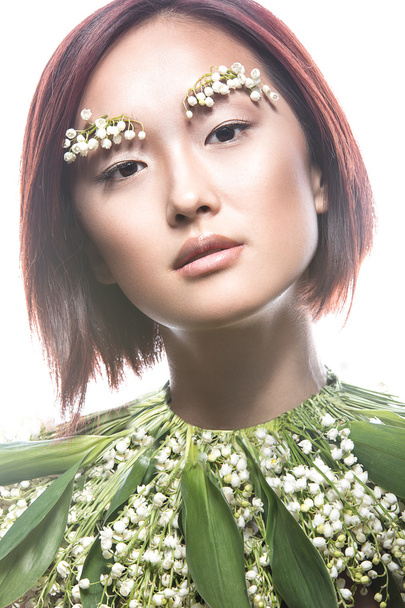 Fashion beautiful girl oriental type with delicate natural make-up and flowers. Beauty face.  - Foto, immagini