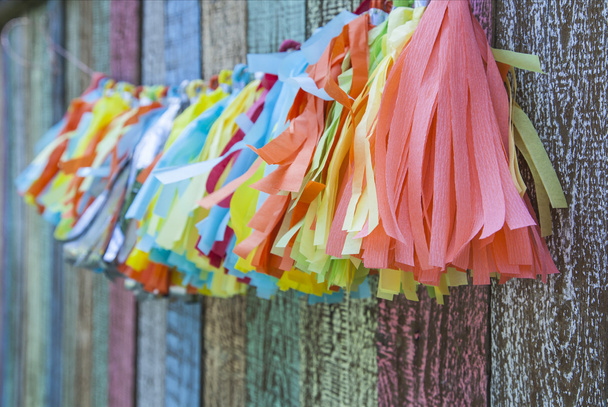 bright colorful paper garland on the fence - Φωτογραφία, εικόνα