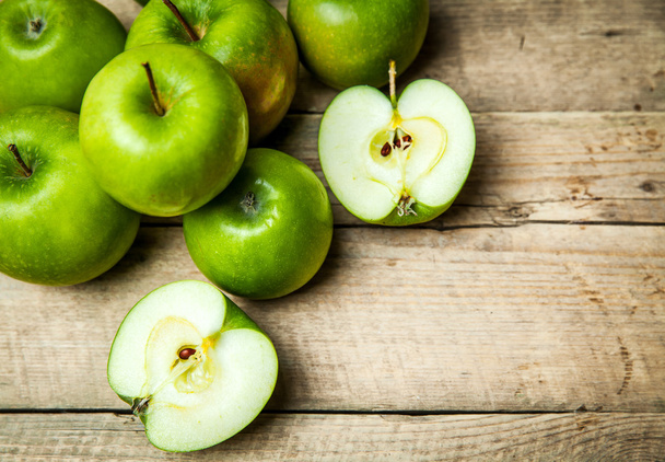 fruit. Ripe green apples on wooden background - 写真・画像