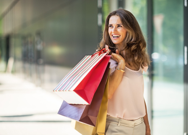 Full length portrait of happy young woman with shopping bag - Photo, Image