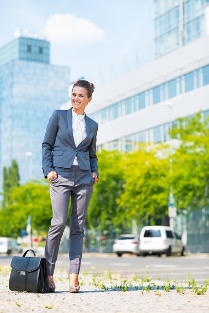 Full length portrait of happy business woman with briefcase in o - Foto, Imagem