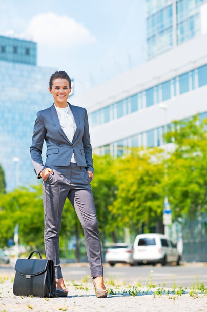 Full length portrait of happy business woman with briefcase in o - Фото, изображение