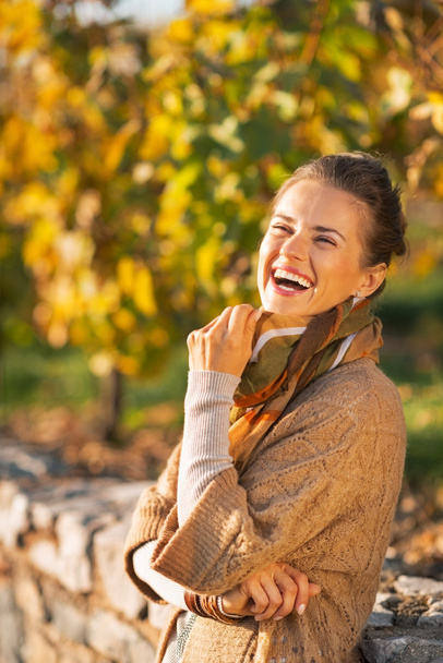 Portrait of smiling young woman in autumn outdoors - Photo, image