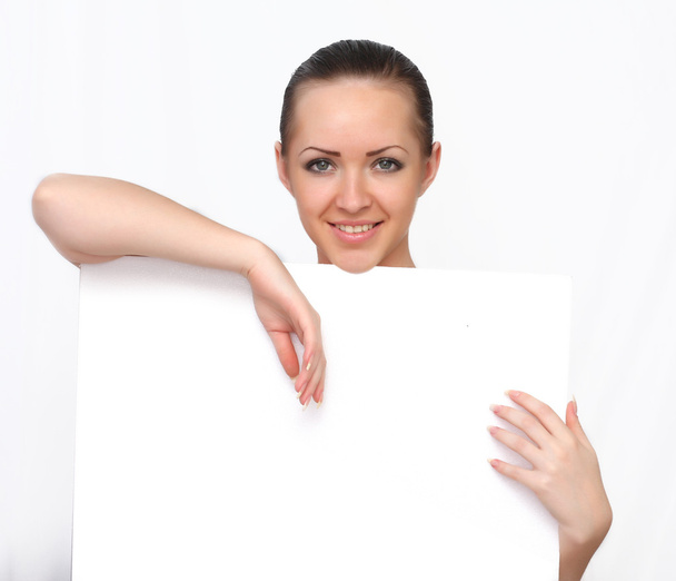 Beautiful woman holding a blank paper, billboard - Фото, изображение