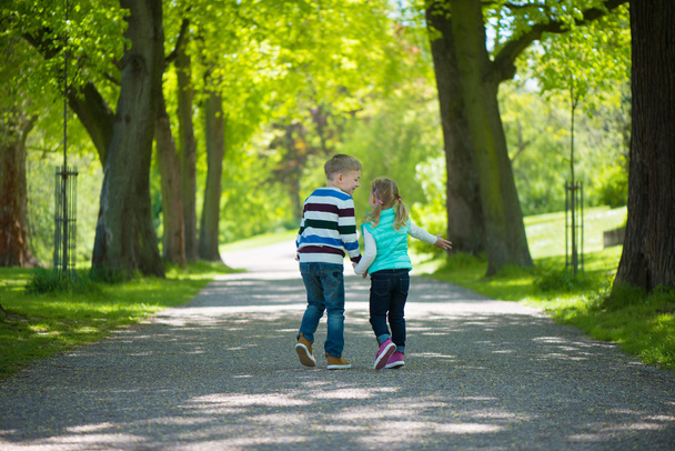 Two happy children walking in park - Foto, imagen
