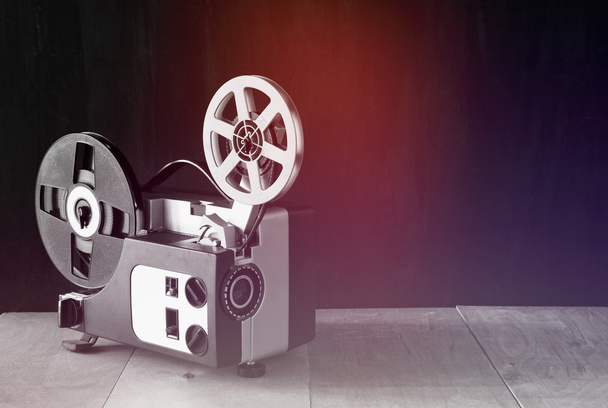 old 8mm Film Projector over wooden table and textured background - Fotoğraf, Görsel