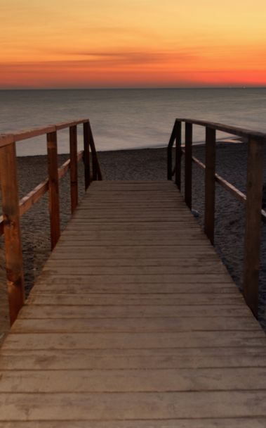 Pontile verso il mare al tramonto - Foto, immagini