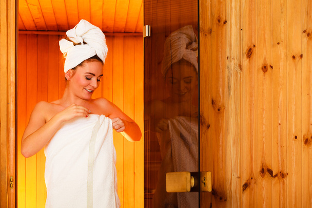 Woman relaxing in wooden sauna - Photo, Image