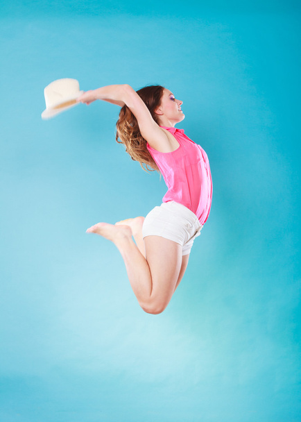 Summer woman in straw hat jumping - 写真・画像