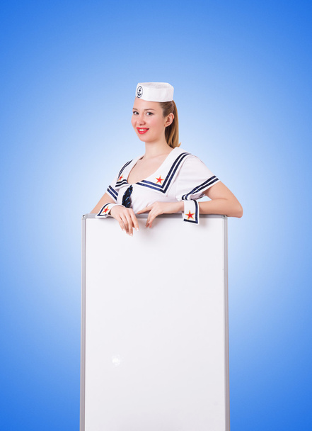 Mujer marinera con tablero en blanco contra el gradiente
 - Foto, imagen