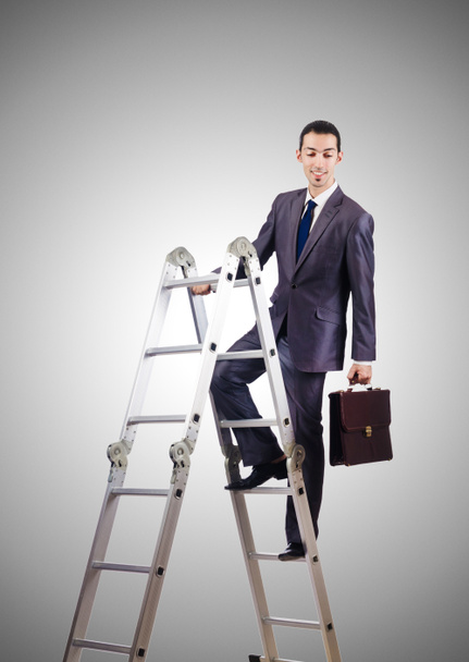 Businessman climbing career ladder against gradient  - Photo, Image