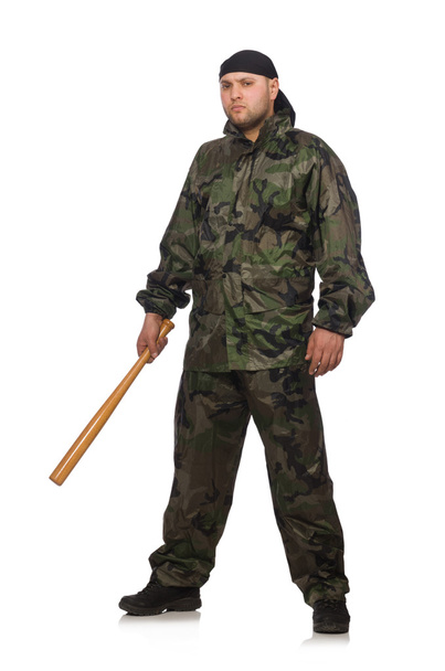 Junger Mann in Soldatenuniform mit Knüppel auf weißem Untergrund - Foto, Bild