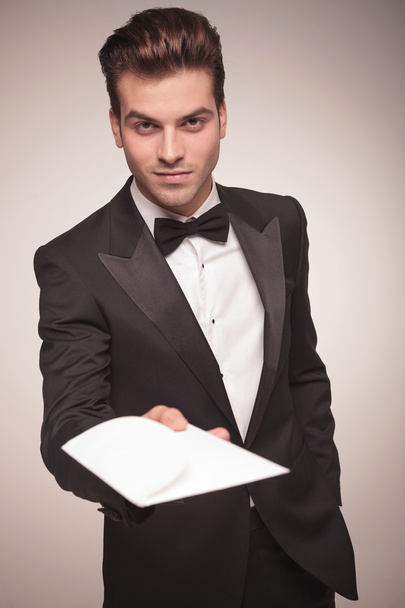 Attractive young business man offering you a invitation. - Foto, Imagen