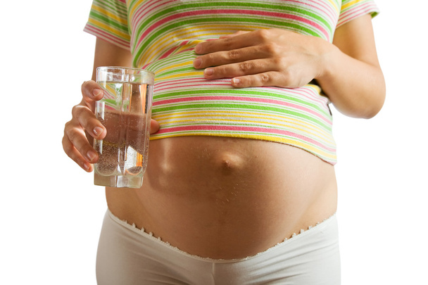 Pregnant girl with water glass - Foto, Bild