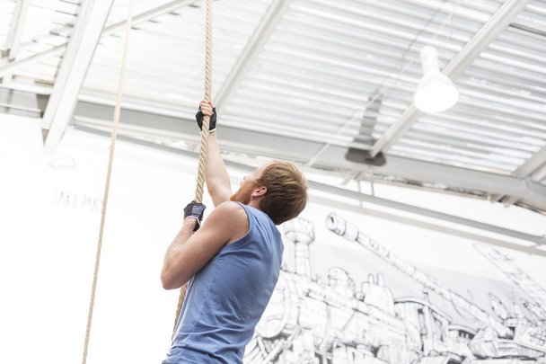 dedicated man climbing rope - Photo, image