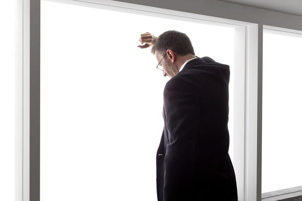 businessman looking out window - Фото, изображение